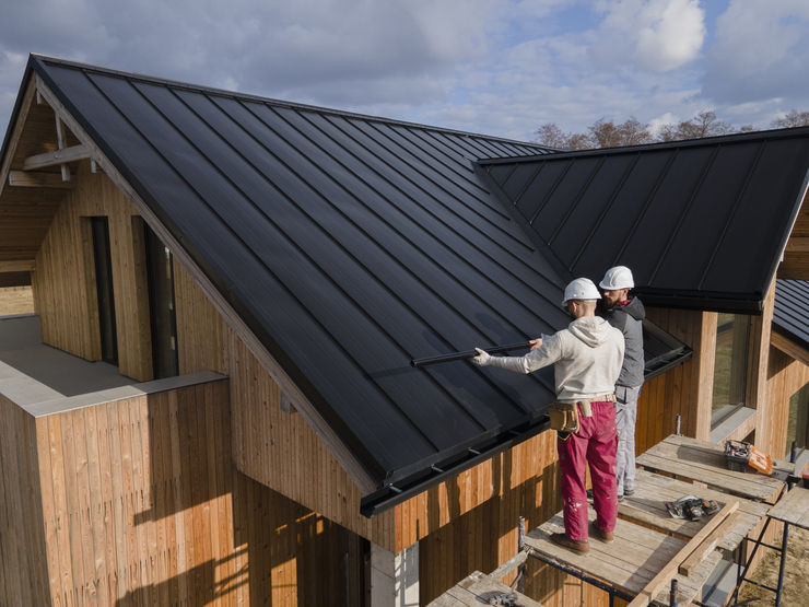 Header full shot roofers working together with helmets